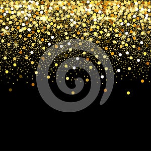 Falling golden particles on a black background