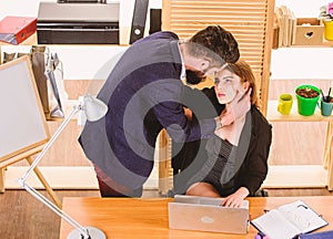 Falling in love. Man flirting with pretty woman at work. Love affair of bearded man and sexy woman. Couple in love