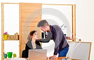 Falling in love in office. Workplace romance of handsome man and sexy woman in office. Couple in love conducting affair