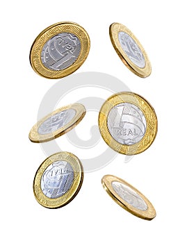 Falling one brazilian real coins isolated on white background photo