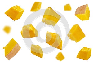 Falling pumpkin slices isolated on a white background, selective focus. Set of pumpkin slices in the air. Pumpkin slices