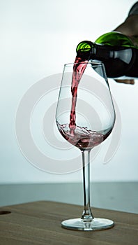 Falling red wine in glass
