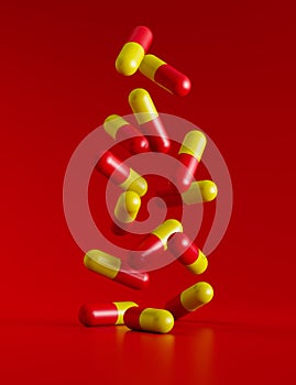 falling red-yellow pills on a red surface