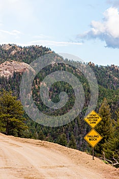 Falling Rock danger sign with mountain view
