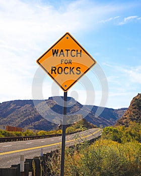 Falling rock sign next to the road