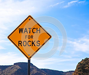 Falling rock sign next to the road