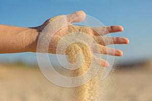 Falling sand through fingers