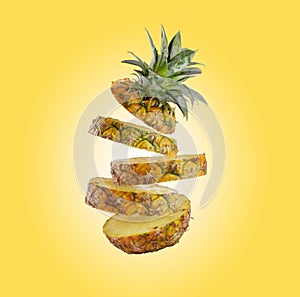 Falling slice pineapple isolated on yellow background