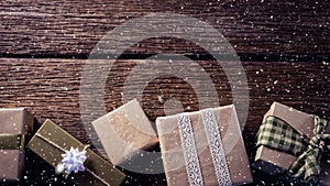 Falling snow with Christmas gifts decoration on wood