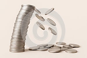 A falling stack of silver coins. Space for text.