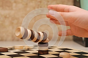 Falling tower of drafts on a chess field