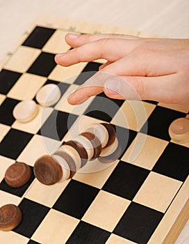 Falling tower of drafts on a chess field