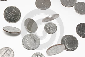 Falling US coins on isolated background