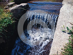 Falling Water Flow Of Farm Irrigation Channel In Agricultural Area At The Village