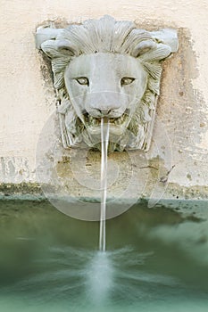 Falling water from lion head fountain