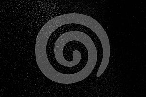 The falling white snow on a black background