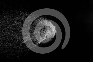 The falling white snow on a black background