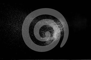 The falling white snow on a black background