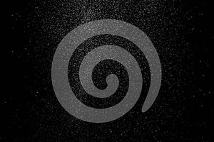 The falling white snow on a black background