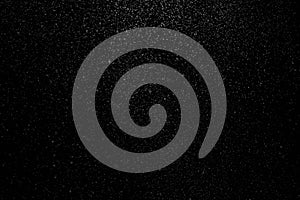 The falling white snow on a black background