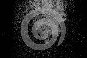 The falling white snow on a black background