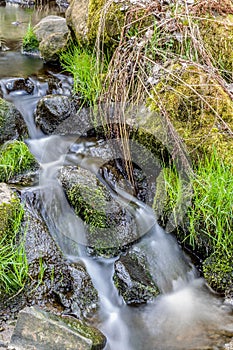 Falls on the small mountain river in a wood