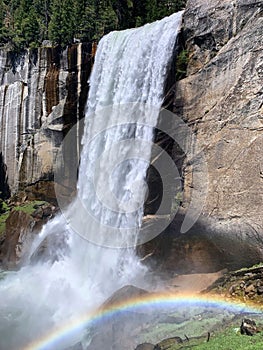 Falls in Yosemite National Park, California, during spring snowmelt and a rainbow