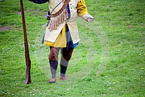 Falmouth, Cornwall, UK - April 12 2018: Historical military re-enactor dressed in blue and yellow Tudor clothes with leather