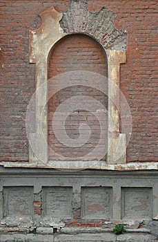False arched window in an old brick wall