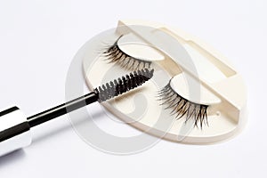 False eyelash set and mascara brush on white background