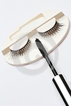 False eyelash set and mascara brush on white background