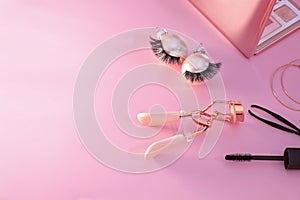 False eyelashes and curler tool cosmetics, Christmas decoration, pinkbackground