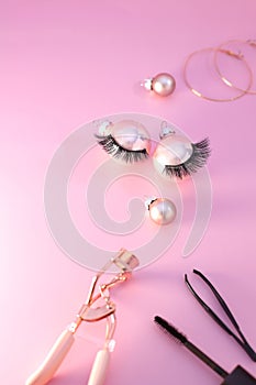 False eyelashes and curler tool cosmetics, Christmas decoration, pinkbackground