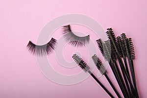 False eyelashes and an eyelash brush on background