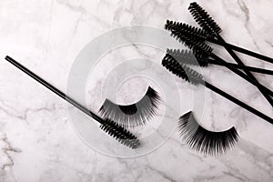 False eyelashes and an eyelash brush on background