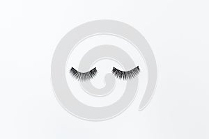 False Eyelashes Lying On White Background. Beauty And Makeup Concept. Flatlay, Mockup, Overhead, Top view
