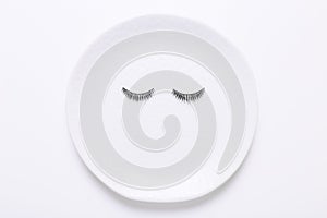 False eyelashes in white round on white background