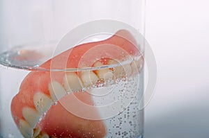 False teeth in glass