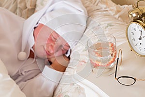 False teeth in glass photo