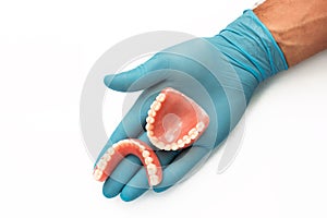 False teeth prosthesis. Doctor Dentist. A dental technician holds a false jaw in his hand. Dental prosthesis