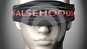 Falsehoods can make things harder to see or makes us blind to the reality - pictured as word Falsehoods on a blindfold to photo