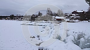 Frozen rocks on shore of lake Siljan in Tallberg near Rattvik in Dalarna in Sweden photo