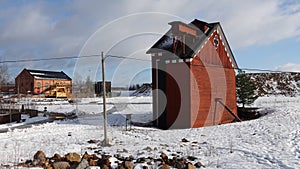 Falun red painted waterpump building of Falun copper mine pit in winter in Sweden