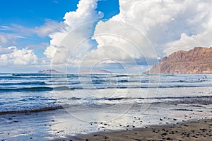 Famara beach at low tide with the islands of archipelago Chinijo in background