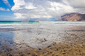 Famara beach at low tide with the islands of archipelago Chinijo in background