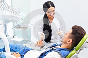 Famele dentist and man in dentists office. Dentist and Patient photo