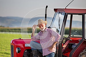 Famer standing beside tractor