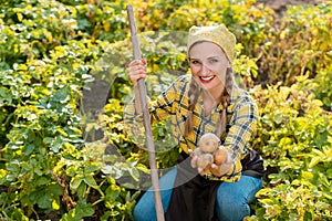 Famer woman presenting her potatoes during harvest