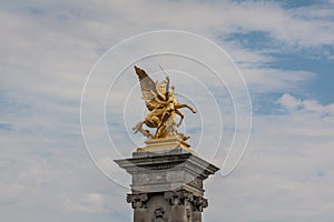 `Fames`, gilt-bronze statues of Fames over the Pont Alexandre III deck arch bridge