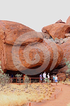Families visit a cave in Uluru Ayers Rock, Australia